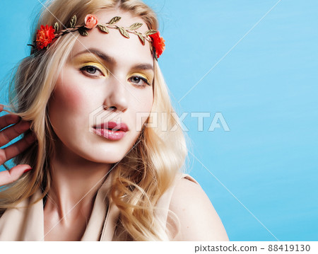 young blond woman dressed like ancient greek godess, beautiful girl hands manicured red nails on blue background copyspace young blond woman dressed like ancient greek godess, beautiful girl hands manicured red nails on blue background copyspace 88419130