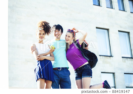cute group of teenages at the building of university with books huggings, diversity nations, having lunch cute group of teenages at the building of university with books huggings, diversity nations, having lunch 88419147