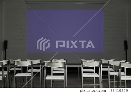 Empty conference room with projection screen and chairs Empty conference room with projection screen and chairs 88419239