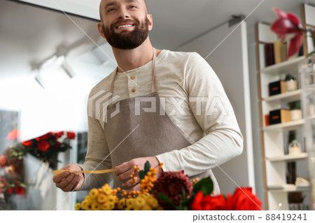 Professional male florist in apron at workplace 88419241