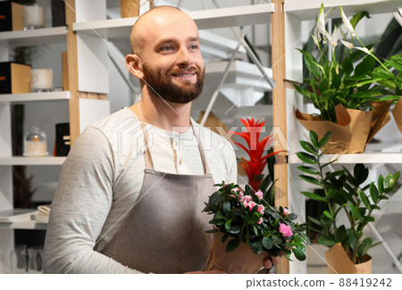 Professional male florist in apron at workplace Professional male florist in apron at workplace 88419242