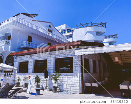 A view at a detail of a modern white apartment building in Lyon, France with blue sky background. 88419250