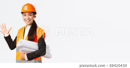 Smiling professional asian female engineer, architect giving five month for construction, carry blueprint of project and looking at camera, guarantee finish work in time, white background Smiling professional asian female engineer, architect giving five month for construction, carry blueprint of project and looking at camera, guarantee finish work in time, white background 88420430