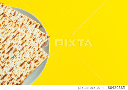 Celebrating the traditional Jewish holiday of Passover. Matzo on a yellow background. Pesach matzah. 88420885