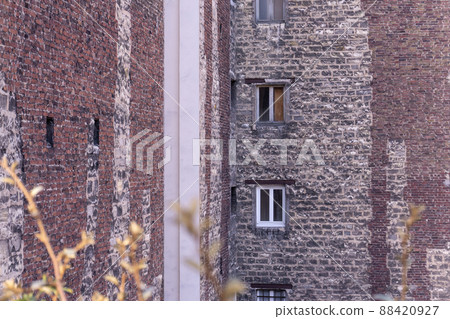 Windows in an old large Parisian brick building 88420927