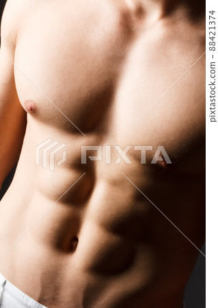 pain relief, sport, bodybuilding, strength and people concept - young man standing over black background 88421374