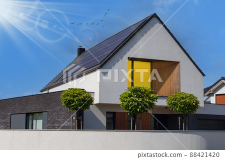 Modern house with solar panels and pool. Clear sky and ray sun. 88421420