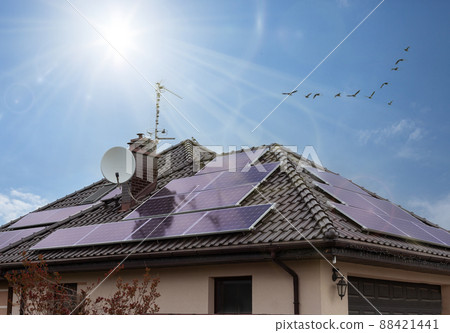 Beautiful modern house with solar panels. Clear sky, sunrays. Beautiful modern house with solar panels. Clear sky, sunrays. 88421441