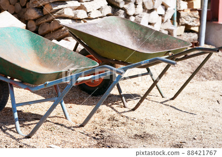 Stacked firewood and unicycle 88421767