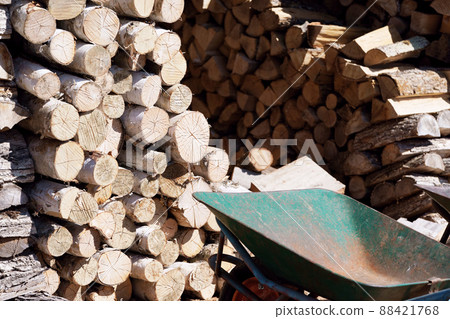 Stacked firewood and unicycle 88421768