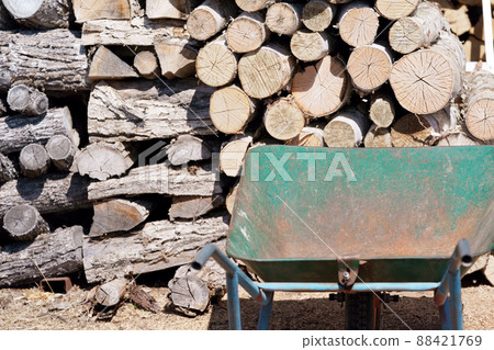 Stacked firewood and unicycle Stacked firewood and unicycle 88421769