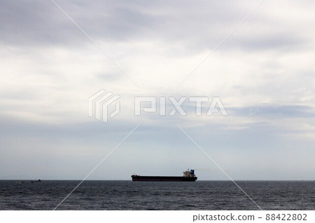 A cargo ship floating in the Seto Inland Sea 88422802