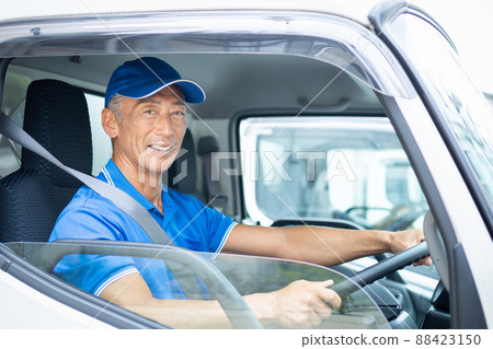 Middle male driver driving a truck 88423150