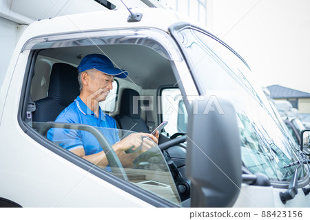 Middle male driver driving a truck 88423156