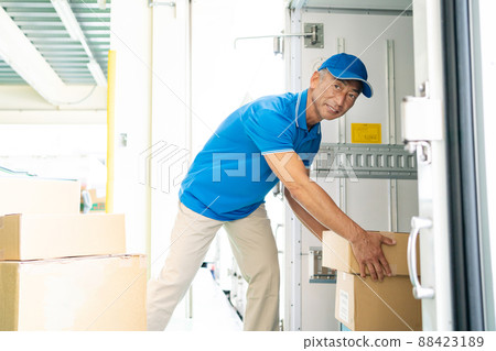 Senior male driver working in a warehouse Senior male driver working in a warehouse 88423189