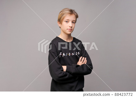 Portrait of a young handsome guy with a stylish haircut in a black sweatshirt Portrait of a young handsome guy with a stylish haircut in a black sweatshirt 88423772