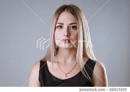 portrait of a young happy girl on a light background portrait of a young happy girl on a light background 88423895