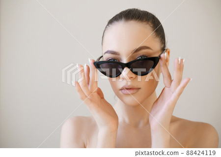 Woman face in sunglasses. Girl face close up portrait of woman. Young girl 88424119