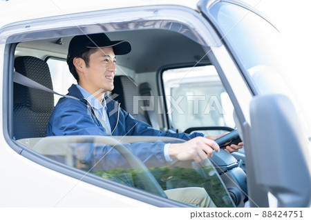 Male driver driving a truck 88424751