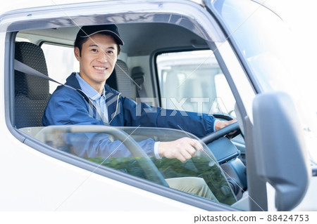 Male driver driving a truck 88424753