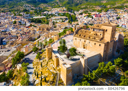 Aerial view of fortified castle and Basilica on hill in Caravaca de la Cruz, Spain 88426796