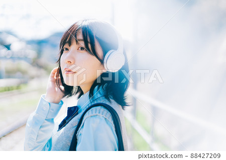 高中女生在車站的平台上聽音樂 88427209