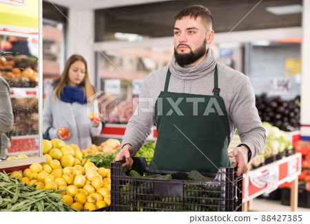Positive man who is standing with box vegetarian in the market 88427385