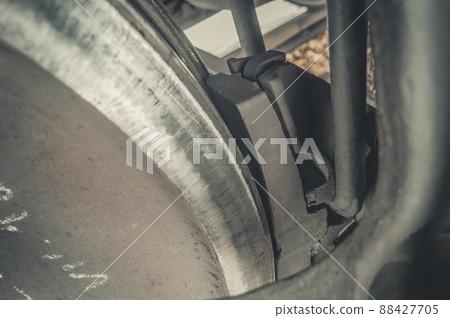 Brake pad of a railway car. Braking system for the wheelsets of wagons on the railway. Selective focus Brake pad of a railway car. Braking system for the wheelsets of wagons on the railway. Selective focus 88427705