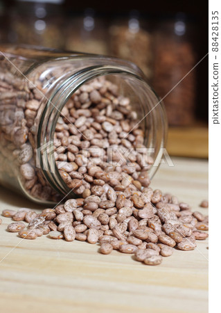 Jar of Pinto Beans Spilled on Kitchen Table Jar of Pinto Beans Spilled on Kitchen Table 88428135