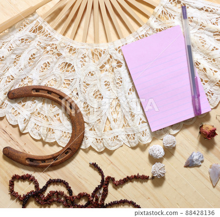 Horseshoe With Vintage Lace Fan Beads and Arrowheads on Wooden Background 88428136
