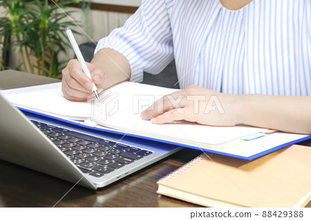 A woman taking a note A woman taking a note 88429388