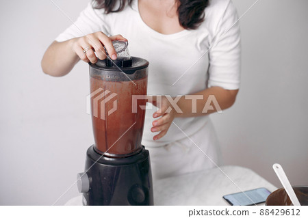 Confectioner mixes the ingredients. Lady is preparing dessert.Woman bakes a cake. Confectioner mixes the ingredients. Lady is preparing dessert.Woman bakes a cake. 88429612