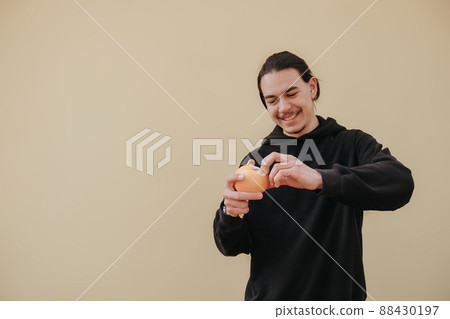 Bearded young man 20s years old in white shirt hold in hand half of grapefruit isolated on blue pastel background studio portrait. Skin care healthcare procedures concept. Mock up copy space 88430197