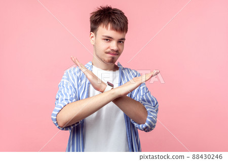 There is no way. Portrait of disappointed young brown-haired man with small beard and mustache in casual shirt crossing hands, warning with end gesture. indoor studio shot isolated on pink background 88430246