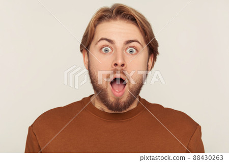 Portrait of emotional bearded man on gray background. 88430263