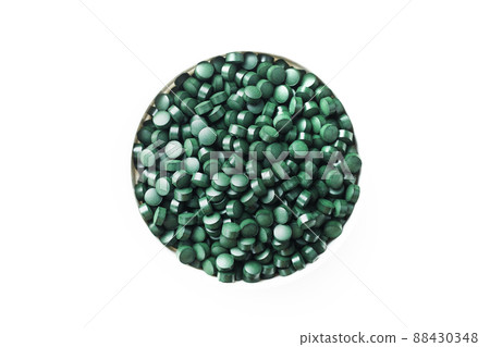 Green tablets made of natural organic spirulina in a cup on a white background with free space Green tablets made of natural organic spirulina in a cup on a white background with free space 88430348