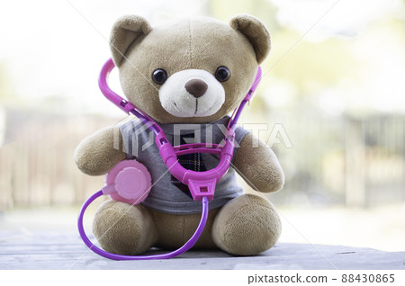 Brown teddy bears wore a stethoscope around the neck. Health care concept. And free space for your text. 88430865
