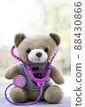 Vertical photo Brown teddy bears wore a stethoscope around the neck. Health care concept. And free space for your text. 88430866