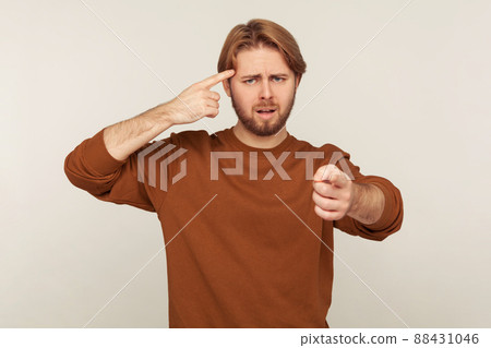 Portrait of emotional bearded man on gray background. 88431046