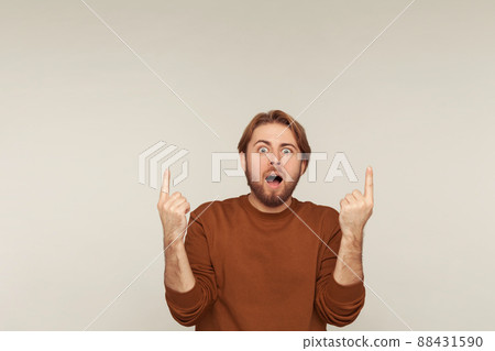 Portrait of emotional bearded man on gray background. 88431590