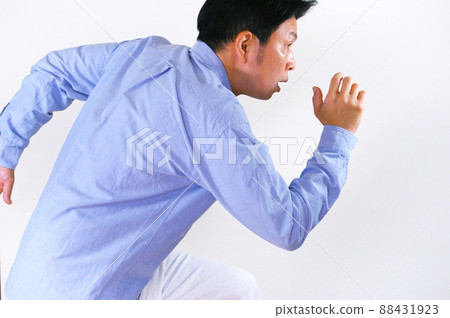 A man running in a casual shirt 88431923