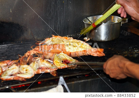 Lobsters grilled over charcoal stove at the street market. Lobsters grilled over charcoal stove at the street market. 88433852