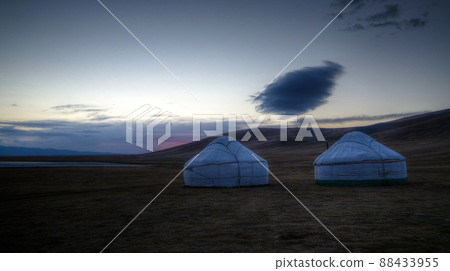 Cloud over the yurts at the shore of Song Kol Lake at the dawn, Kyrgyzstan 88433955