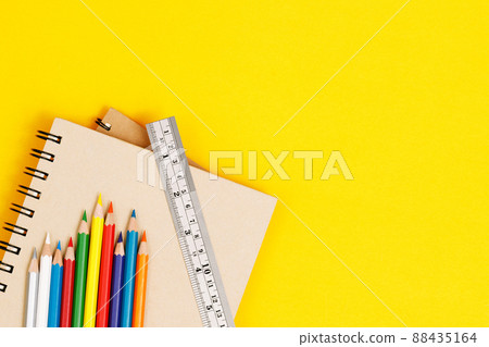 Top view notebooks and accessories studying in the library at school yellow background idea education Top view notebooks and accessories studying in the library at school yellow background idea education 88435164