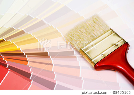 A painter is choosing a paint shade for the interior of the house's walls. with interior A painter is choosing a paint shade for the interior of the house's walls. with interior 88435165