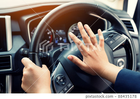 man pushing horn while driving sitting of a steering wheel press car, honking sound to warn other people in traffic concept. man pushing horn while driving sitting of a steering wheel press car, honking sound to warn other people in traffic concept. 88435178