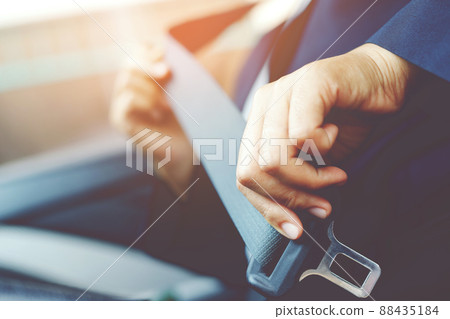 Close Up of people woman hand fastening seat safety belt in car for safety before driving on the road. concept transport travel. soft focus. 88435184