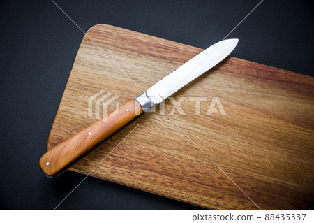 Traditional pocket knife on a wooden cutting board Traditional pocket knife on a wooden cutting board 88435337