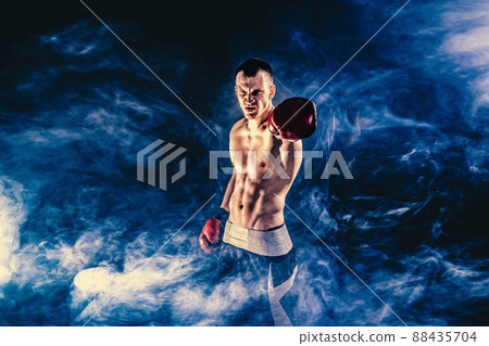 Fitness and boxing concept. Boxer, man fighting or posing in gloves on dark background. Individual sports recreation 88435704