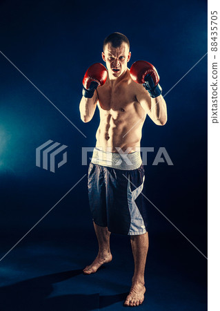 Fitness and boxing concept. Boxer, man fighting or posing in gloves on dark background. Individual sports recreation 88435705